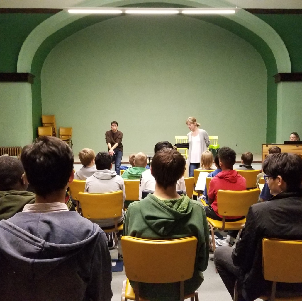 students sitting in classroom listening to instructors